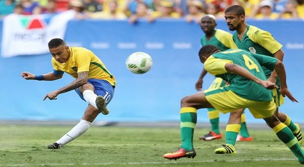 brazilian winger neymar l shoots the ball against three south african defenders